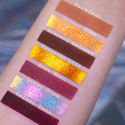 Seven warm shades swatched on light skin: Barefoot, Golden Glow, Bronzed Goddess, Peruvian Lily, Rose Moon, Lunar Glow, and Velvet Dune