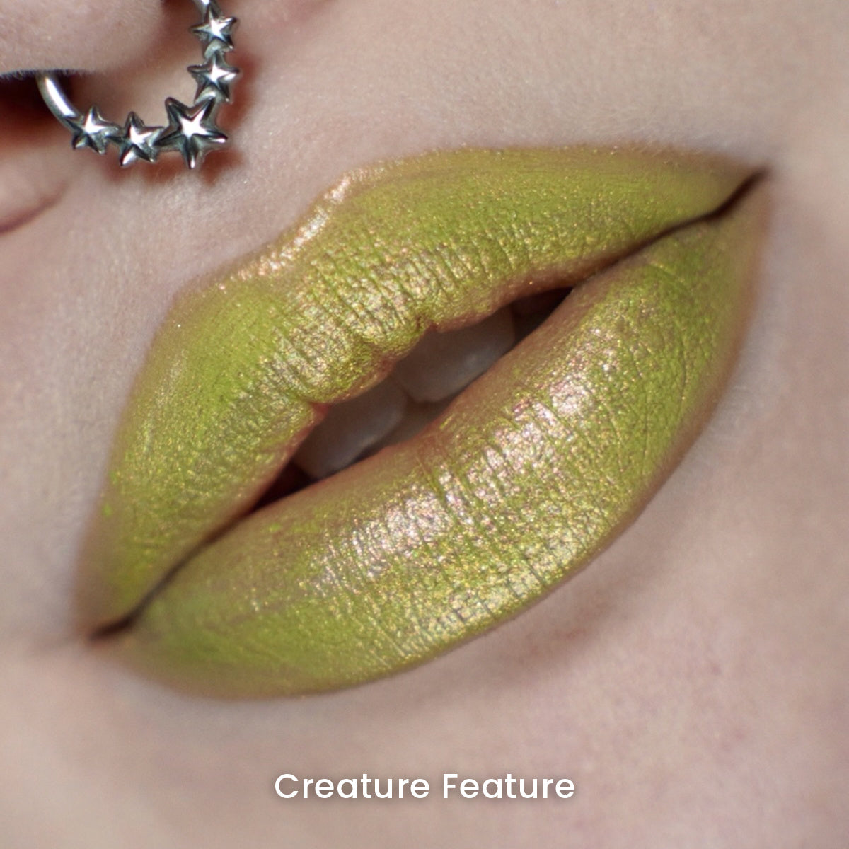 Creature Feature worn on the lips: chartreuse green with a gold and pink sheen, on light skin