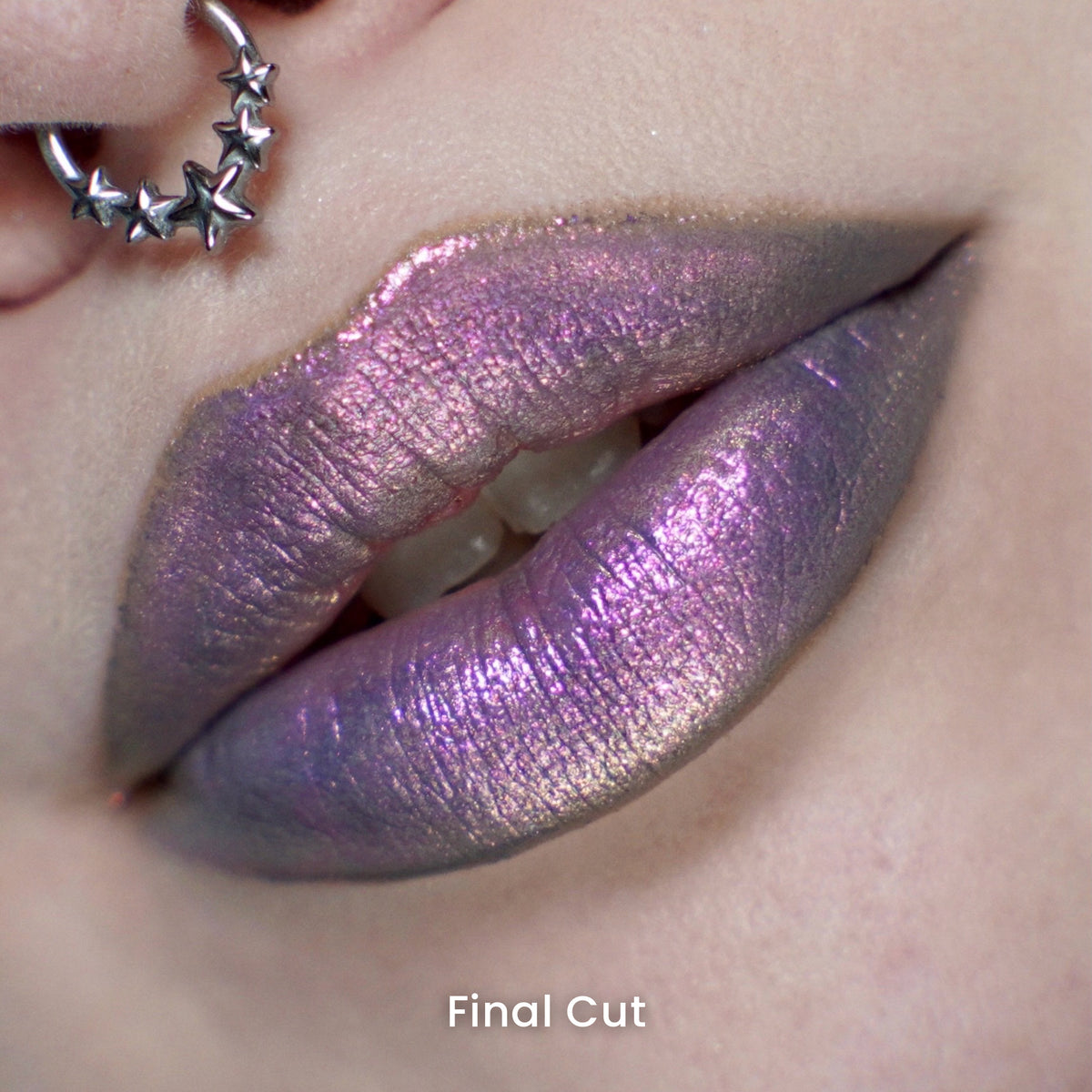 Final Cut worn on the lips: violet with a pink sheen and grey-green edges, on light skin