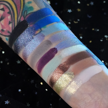 Gargoyle swatches on a tattooed arm over starry black fabric