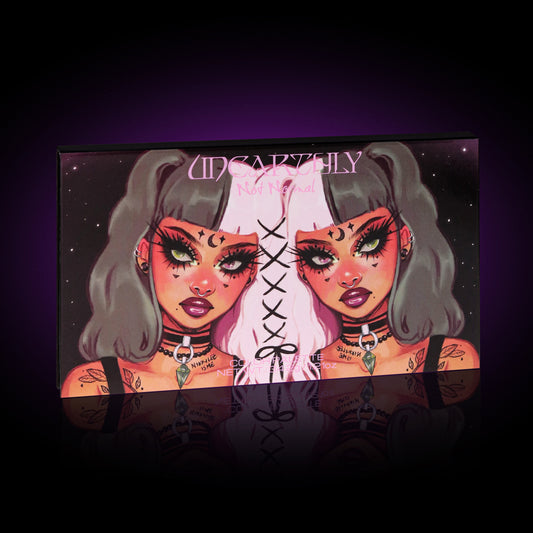 The Not Normal palette box from Unearthly Cosmetics, twin-girl cover artwork, in a purple glow